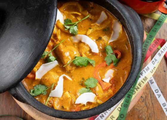 Moqueca de Peixe com banana-da-terra e lascas de coco, servidas com arroz, farofa de dendê e pirão